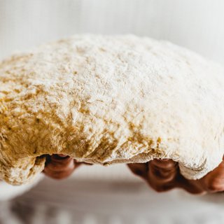 Bäcker zeigt Teig zum Brot backen